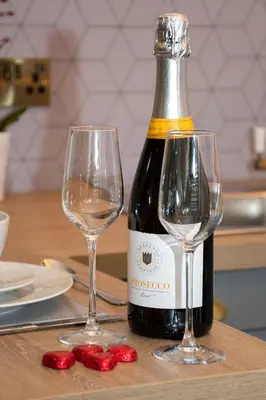 a bottle of wine and two glasses on a table at Station View, Dunblane in Dunblane