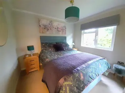 a bedroom with a bed and a window at Willow Lodge Auchterarder in Auchterarder