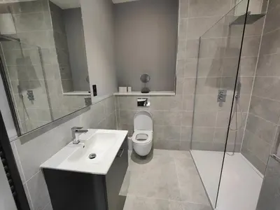a bathroom with a toilet and a sink and a shower at JOIVY Luxurious Apt on Notable George Street in Edinburgh