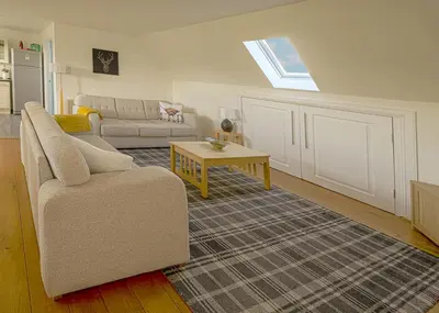 a living room with a couch and a table at Castle View - Home from Home in Stirling