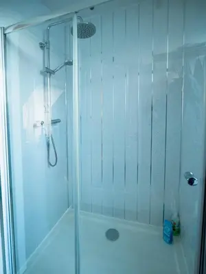 a shower with a glass door in a bathroom at Castle View - Home from Home in Stirling