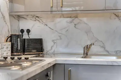 a kitchen with a sink and a counter top at The Garden Flat, Loch Lomond in Alexandria
