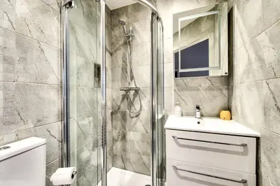 a bathroom with a shower and a sink at Stylish & Spacious 3 Bedroom Apt in Finnieston, West End in Glasgow