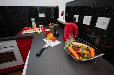 a kitchen counter with a bowl of vegetables on it at PREMIER - Chapel House with Driveway! in Cleland