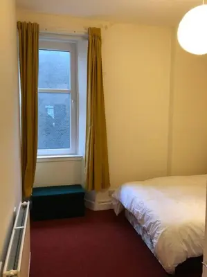 a bedroom with a bed and a window at Pier Head in Largs