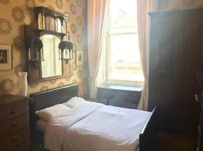 a bedroom with a bed and a window and a dresser at 2 Chester St in Edinburgh