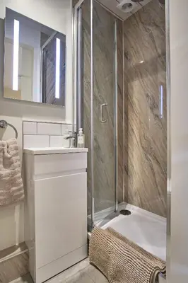 a bathroom with a shower and a sink and a tub at Seòmar Beag in Oban