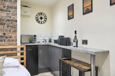a kitchen with a counter top and a microwave at Seòmar Beag in Oban