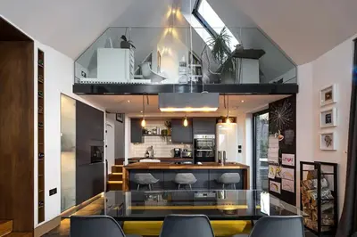 a kitchen with a glass table and some chairs at Roselea Cottage in Luss