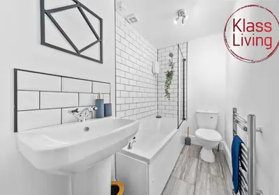 a white bathroom with a sink and a toilet at Garturk Apartment by Klass Living Coatbridge in Coatbridge