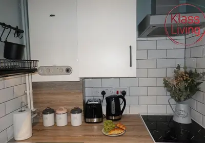 a kitchen with a counter top with a coffee maker at Mossend Apartment by Klass Living Bellshill in Mossend
