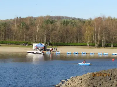 a group of people in boats on a lake at Levenside Holiday Apartment, Balloch, Loch Lomond in Balloch
