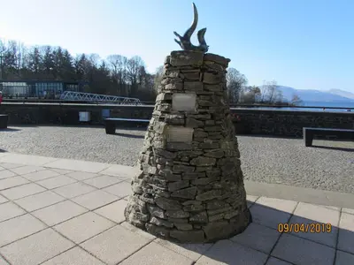 a stone wall with a statue on top of it at Levenside Holiday Apartment, Balloch, Loch Lomond in Balloch