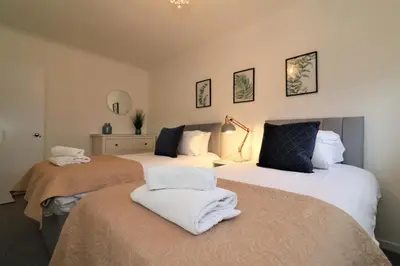 a bedroom with two beds with towels on them at Signature - North View in Cambusnethan
