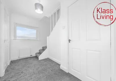 a white room with a door and a staircase at Berwick Apartment by Klass Living Coatbridge in Coatbridge