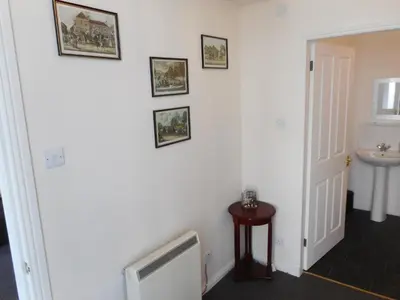 a bathroom with a sink and a white wall at THE COACH HOUSE in Moffat