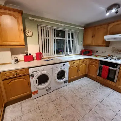 a kitchen with a washer and dryer in it at PREMIER - Whifflet Apartment in Coatbridge