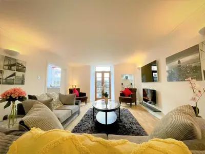 a living room with a couch and a table at Elite 3 Bed New Town Apt with Private Walled Garden in Edinburgh