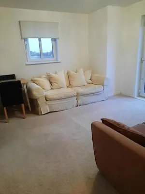 a living room with a couch and a table at Pond View Upper in Airdrie