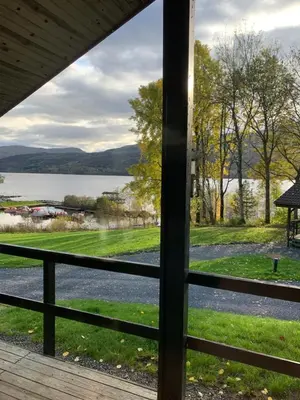 a view of a lake from a porch at Milton Bay Luxury lodge wrapped in exceptional scenery in Morenish