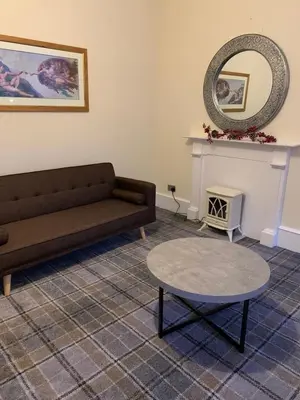 a living room with a couch and a table at clyde hub in Gourock