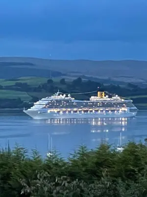 a large cruise ship sitting in the water at clyde hub in Gourock