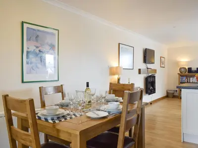 a dining room with a wooden table with chairs at White Wisp in Kinross