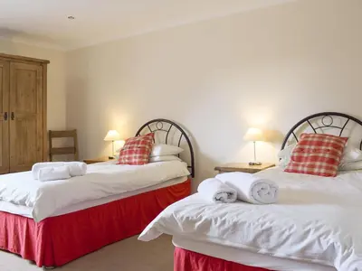 two beds sitting next to each other in a bedroom at White Wisp in Kinross