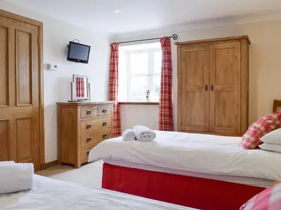 a bedroom with two beds and a window at White Wisp in Kinross