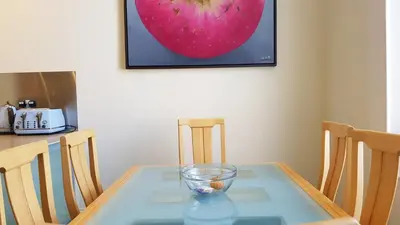 a glass table with a bowl on top of it at Stylish Central Edinburgh Apartment in Edinburgh