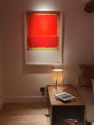 a living room with a table and a painting on the wall at The Church Tower in Crieff