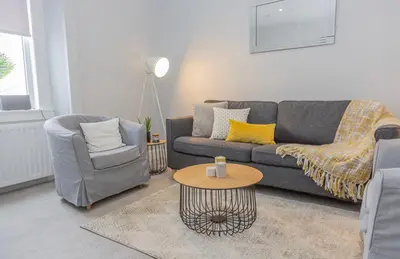 a living room with a couch and a table at The Mila - Ayr Racecourse - Coorie Doon Stays in Ayr