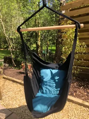 a black hammock hanging in a garden at Ayrshire Airstream in Galston