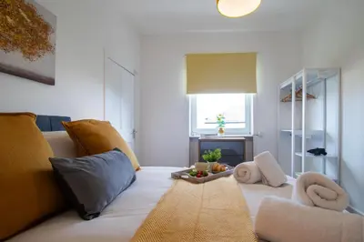 a living room with a couch and a fireplace at Bella House - 3 bed house in Glasgow in Glasgow