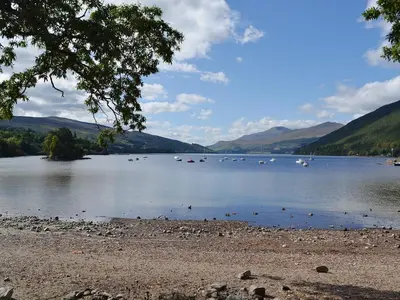 a lake with lots of boats in the water at The Quaich in Stron-fearnan