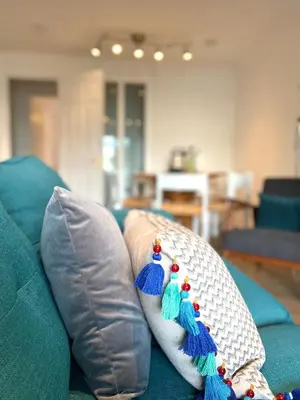 a couch with two pillows on top of it at Bellevue Apartment in Largs