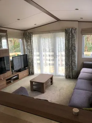 a living room with a couch and a tv at River View 46 in Dunoon