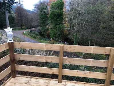 a wooden fence in front of a garden at River View 46 in Dunoon