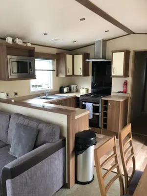 a kitchen with a couch and a stove top oven at River View 46 in Dunoon