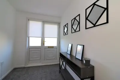 a room with a door and a table with mirrors at Signature - Honeywell House in Chapelhall