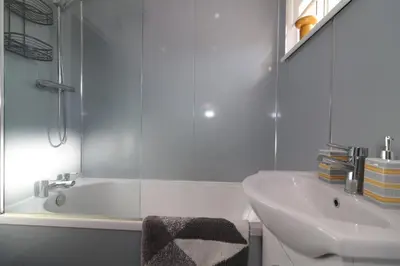 a bathroom with a shower and a sink and a tub at Signature - Honeywell House in Chapelhall