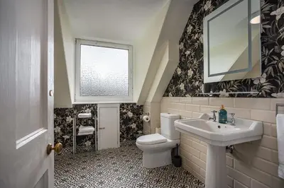 a bathroom with a toilet and a sink and a window at Annfield House, Callander in Callander