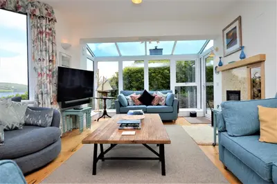 a living room with couches and a coffee table at The Neuk in Tighnabruaich