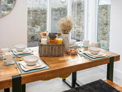a dining room table with a breakfast table at Forget Me Not Cottage in Culross