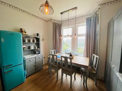 a kitchen with a wooden table and a blue refrigerator at Upper Villa, Tighnabruiach, Argyll & Bute in Tighnabruaich
