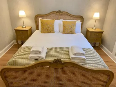 a large bed with two nightstands and two lamps at Upper Villa, Tighnabruiach, Argyll & Bute in Tighnabruaich