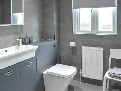 a bathroom with a white toilet and a sink at The Lodge in Linlithgow