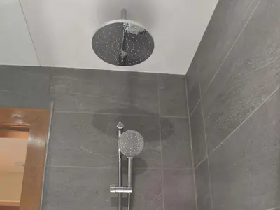 a shower with two lights on the wall at The Lodge in Linlithgow