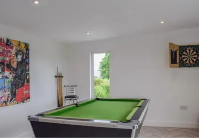 a room with a pool table and a window at 5 Bed cottage with Hot tub in Bannockburn