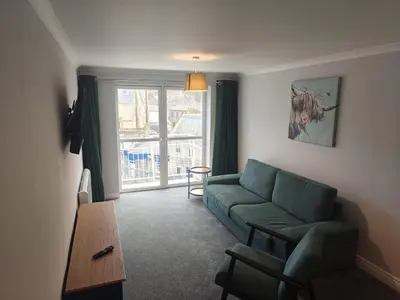 a living room with a couch and a table at Station View in Oban